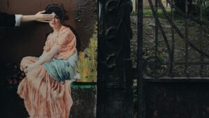 A creative collage of a lady in classical attire against a textured street wall near an ornate gate.