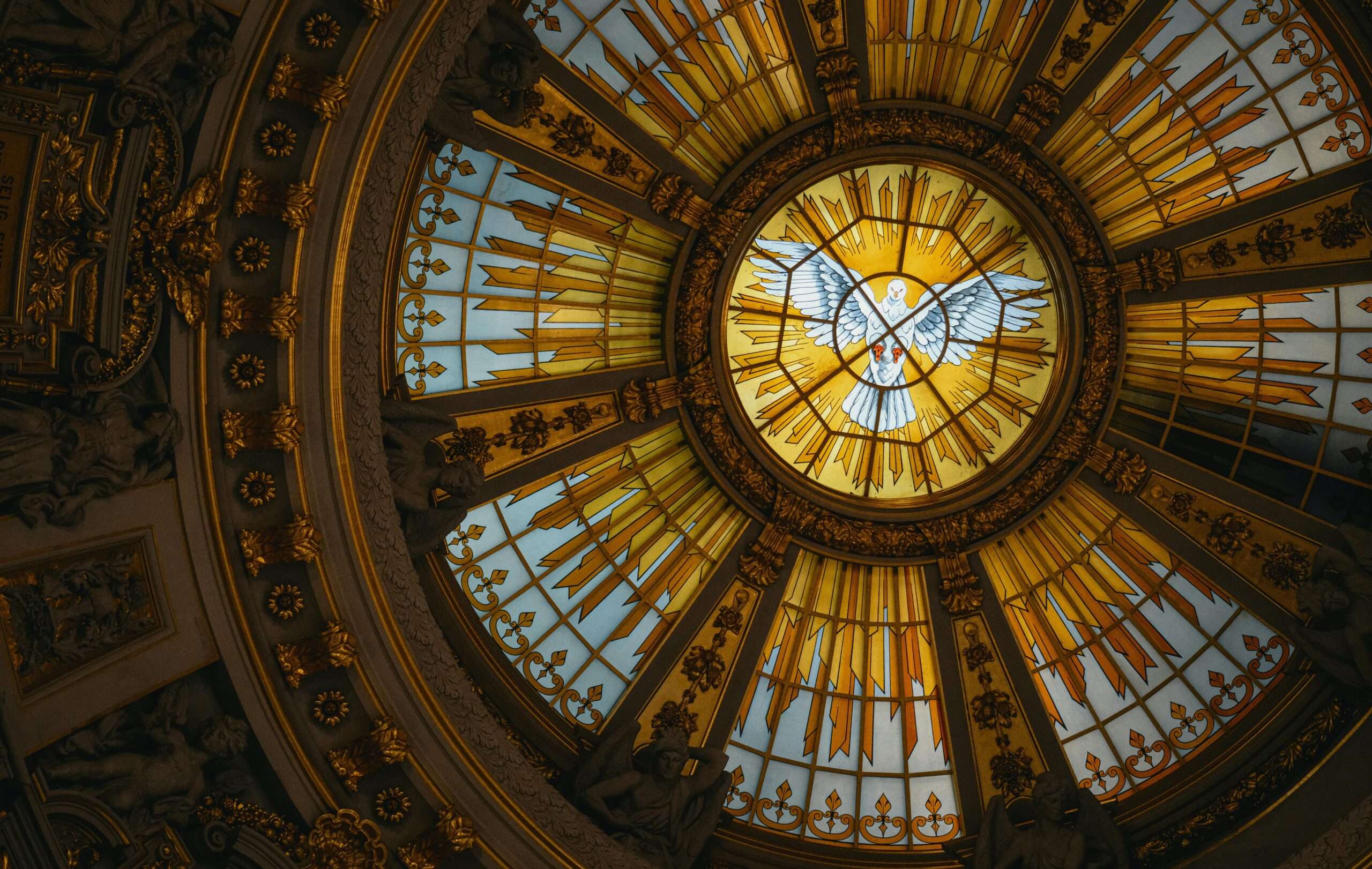 Beautiful stained glass dome depicting a dove in a golden, ornate setting.